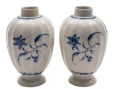 A pair of First Period Worcester blue and white tea canisters of baluster fluted form painted in