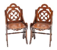 A pair of Victorian oak chairs in Gothic style, in the manner of A.W.N.