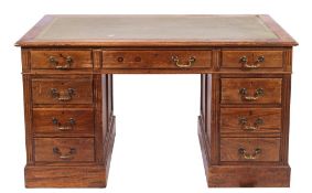 A stained hardwood veneered and leather inset pedestal desk in George III style,