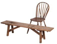 A pine pig bench, 19th century; the single plank top on straight, splayed legs,