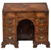 A George II walnut, cross and feather banded kneehole bureau,