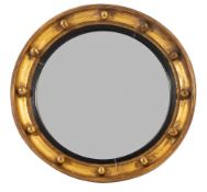 A Regency giltwood framed circular wall mirror,