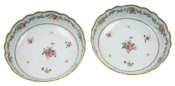 A pair of Chinese famille rose shallow bowls with lobed foliate rims,