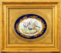 A pair of Sèvres-style porcelain oval plaques each painted with exotic birds in a garden reserved