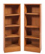 A pair of oak open bookcases, 20th century; possibly for Heals; of rectangular form,