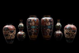 A group of thirteen items of Chinese and Japanese cloisonne variously decorated with flowers,