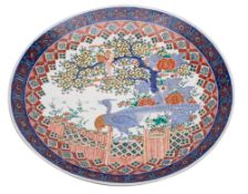 A large Japanese Arita charger decorated in under glaze blue, red,