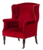 A Regency upholstered wing armchair,