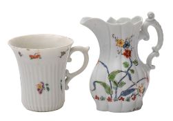 An early Worcester cream jug and a similar coffee cup the jug of lobed form with moulded scroll