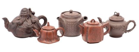 Five Chinese Yixing teapots, one in the form of the seated immortal Li Tieguai,