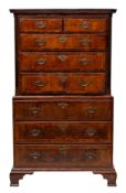 A late George II or George III walnut, crossbanded and feather banded chest on chest,