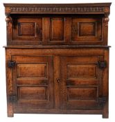 An oak court cupboard, second half 17th century; the upper section with cornice above a canopy top,