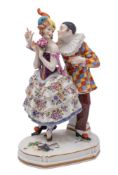 A Continental porcelain 'gold anchor' figure group, of Harlequin and Columbine,