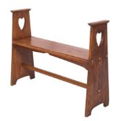 An Arts and Crafts oak hall bench in the manner of Liberty,