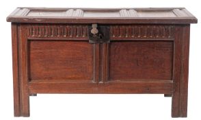 A Commonwealth oak coffer, mid 17th century; the three panel top with 'wire' hinges,