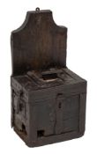 An iron bound oak wall mounting alms box, 17th century; of rectangular form,