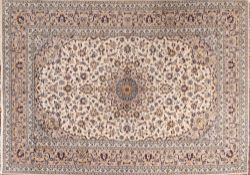 A Kashan carpet, the ivory cartouche field with a central grey geometric flowerhead pole medallion,