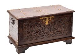 A South East Asian carved and stained hardwood and metal mounted coffer,