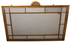 A carved giltwood and composition framed marginal wall mirror, in Neoclassical taste,