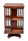 A Victorian revolving mahogany and crossbanded bookcase, late 19th century; of square section,