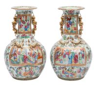 A pair of Canton baluster vases with shaped turnover rims and gilt lion dog and puppy handles,