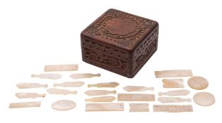 A collection of incised mother-of-pearl gaming counters,