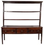 An 18th Century oak dresser, having ovolo moulded cornice over three open shelves,