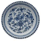 A Chinese blue and white dish with moulded foliate rim, painted with sprays of chrysanthemum, peony,