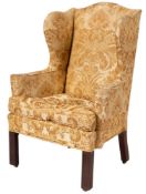A George III upholstered wing armchair,