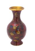 A Chinese cloisonne enamel vase of ovoid form with all-over floral decoration to wine red field, 15.