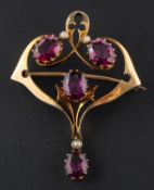 An oval, mixed-cut garnet and seed pearl, openwork brooch/pendant, length ca. 4.
