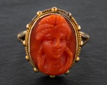 A 19th century, coral cameo ring, depicting the head of a lady, with ropework surround,