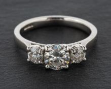 A platinum, round, brilliant-cut diamond three-stone ring, total estimated diamond weight ca. 1.