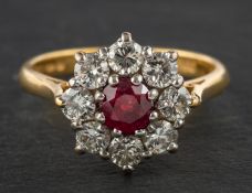 An 18ct gold, round, mixed-cut ruby and round, brilliant-cut diamond cluster ring,