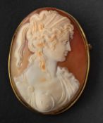 An oval, shell cameo brooch/ pendant, depicting the bust of a lady in profile,stamped '750',