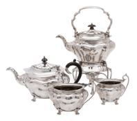 An Edward VII silver matched four piece tea service, makers Walker and Hall,
