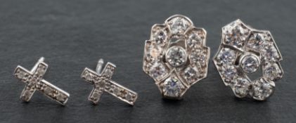 Two pairs of diamond ear studs, including a pair of openwork ear studs,