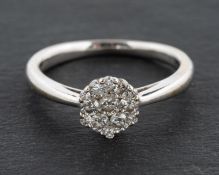 An 18ct gold, round, brilliant-cut diamond cluster ring, total estimated diamond weight ca. 0.