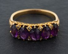 An oval, mixed-cut amethyst, five-stone ring, with rose-cut diamond spacers,