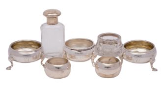A quantity of London silver items comprising: a pair of George II tripod cauldron salts with