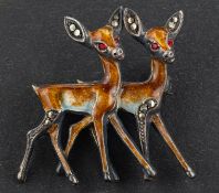 A mid-twentieth century, brown and white enamel and faceted pyrite brooch, depicting two red deer,