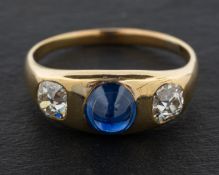 A sugar-loaf, cabochon-cut sapphire and old-cut diamond, three-stone ring,
