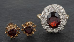 A garnet, single and round, brilliant-cut diamond cluster ring, total estimated diamond weight ca.