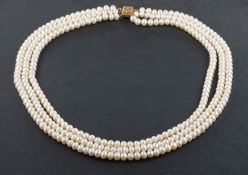 A three-row, fresh-water, cultured pearl necklace, the pearls of off-round form,