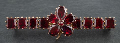 A cushion and pear-shaped garnet bar brooch of flowerhead design, total length ca. 4.