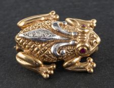 A 9ct, bi-colour gold, frog brooch, with round, mixed-cut rubies for eyes,
