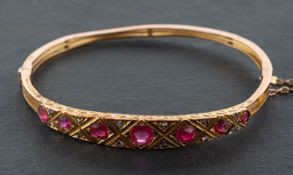 A pink paste and rose-cut diamond, hinged bangle, with geometric engraved decoration to side,