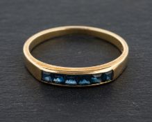 A calibre-cut sapphire, half-eternity ring, stamped '585', length of ring head ca. 1.
