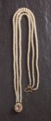 A triple-rowed, graduated, cultured pearl necklace, with 9ct gold clasp set with an amethyst,