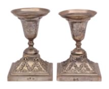 A pair of Portuguese silver desk candlesticks: the urn-shaped sconces with garland decoration,